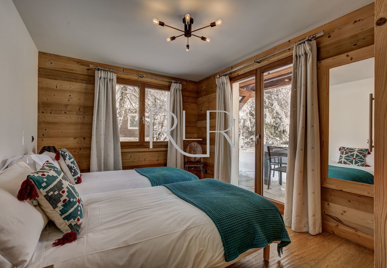 Bedroom 4 of Chalet Capricorne is a flexible double or twin room with access to the terrace
