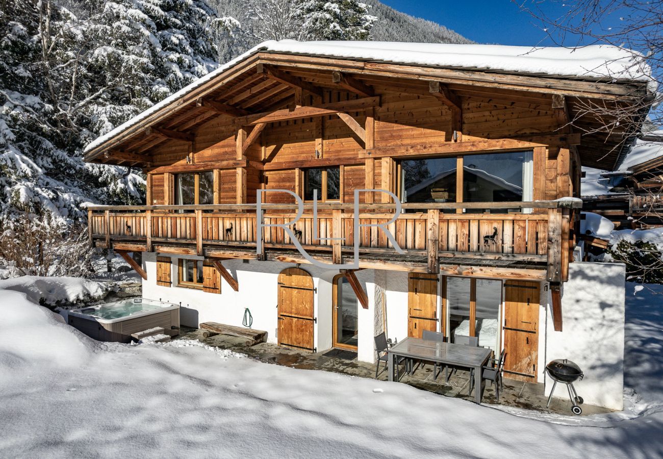 The ground floor hallway of Chalet Capricorne opens onto the terrace with hot tub, dining table and BBQ