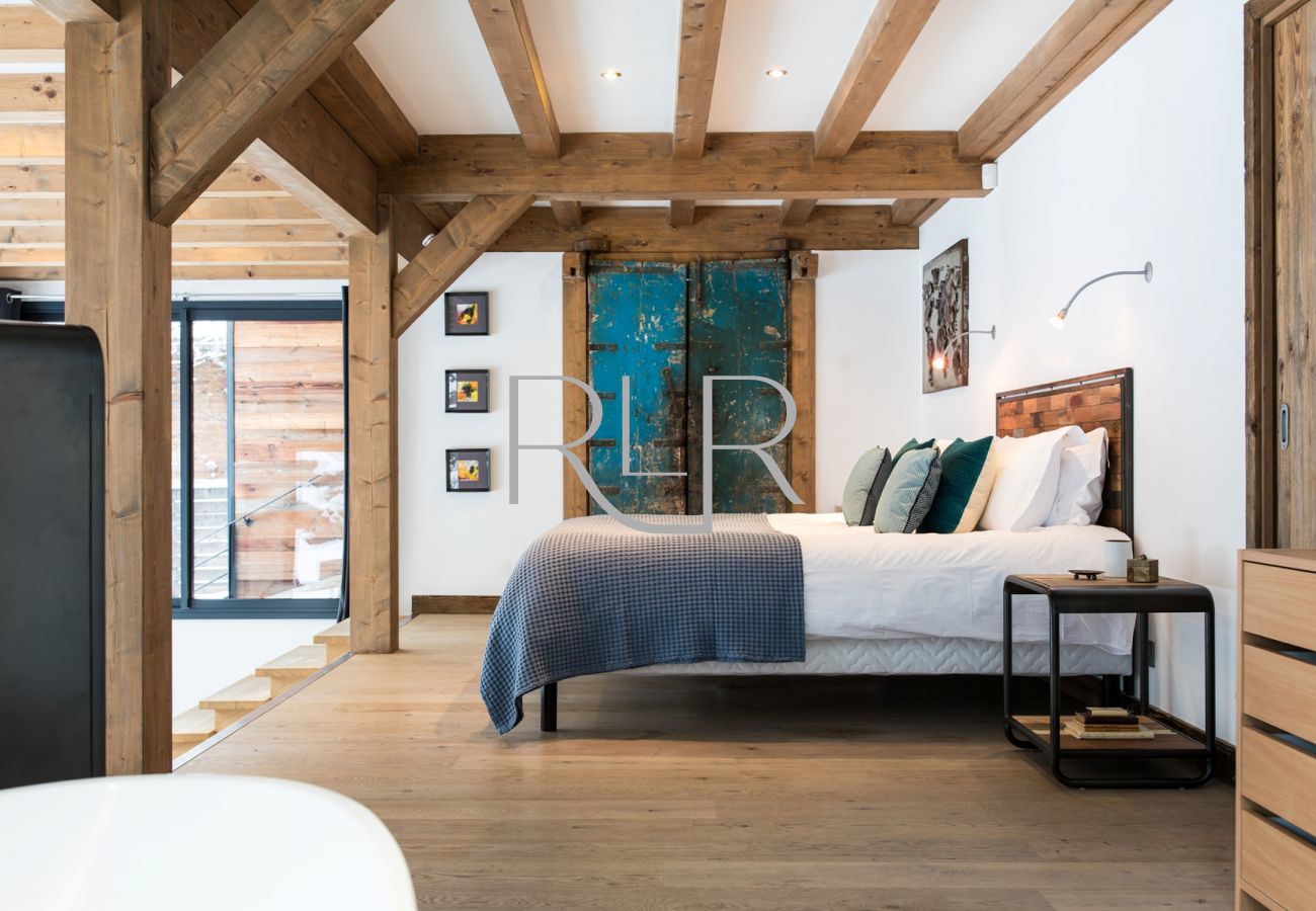 Chalet Belachat's Bedroom 1 is a double room with open steps leading down to a to split-level lounge area   