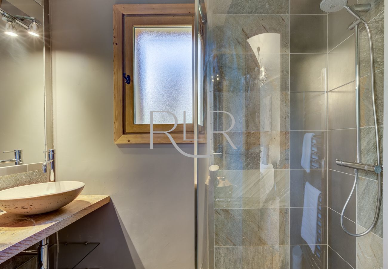 The ensuite to Bedroom 2 of Chalet Sanaz has a shower and basin