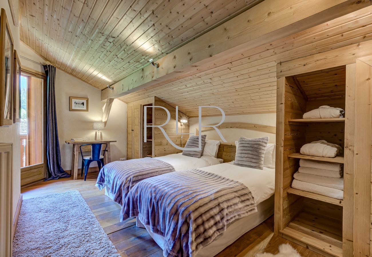 Bedroom 3 of Chalet Sanaz is a flexible double or twin room with a shared balcony
