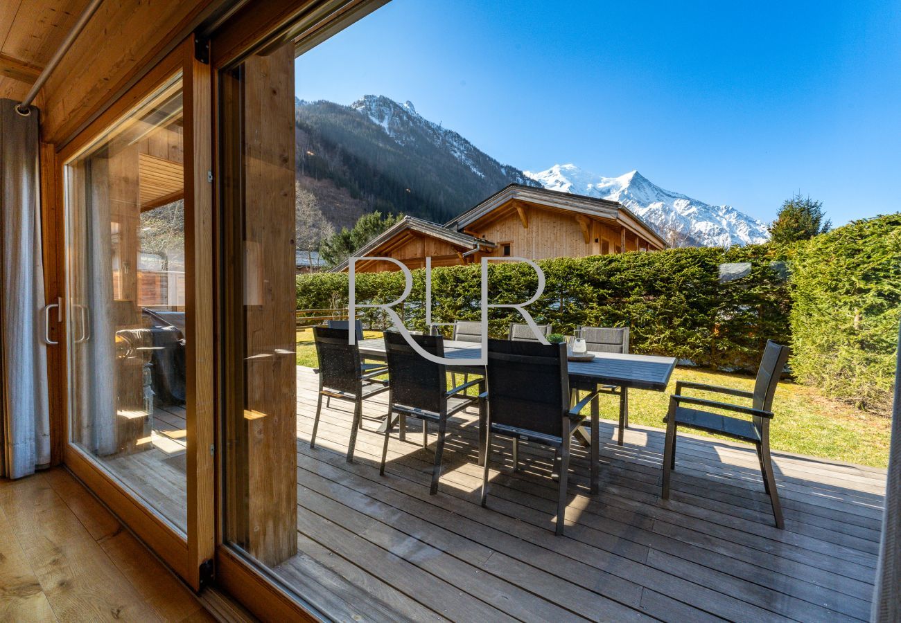 Chalet Planards 1 has outdoor dining furniture on a large wooden deck.