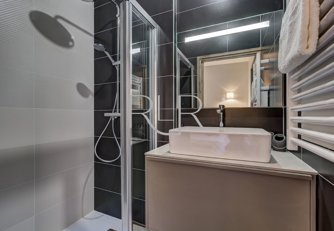 The ensuite to Bedroom 1 of White Pearl C12 has a shower and basin