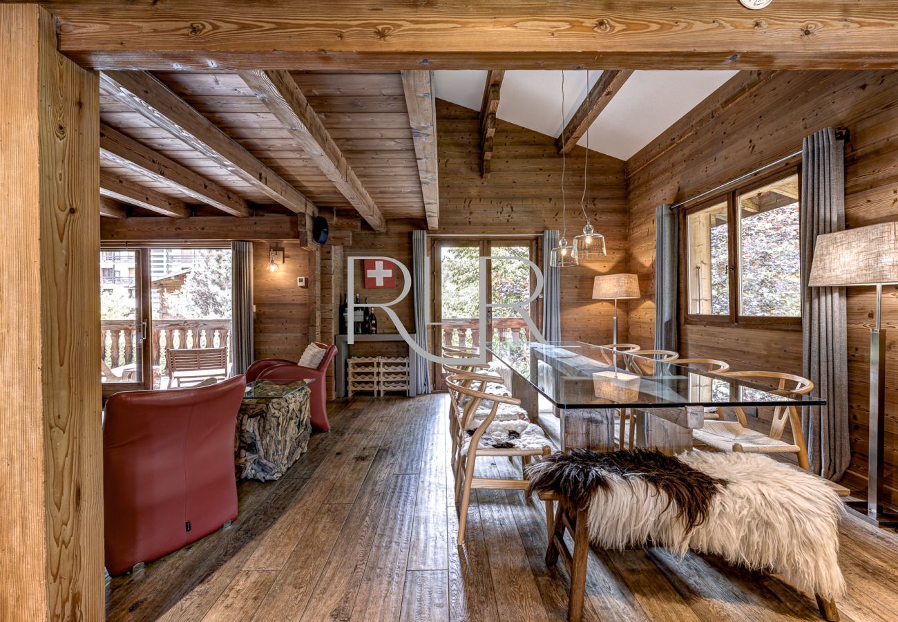 Large dining table leading to the wrap around balcony at Chalet les Sauberands