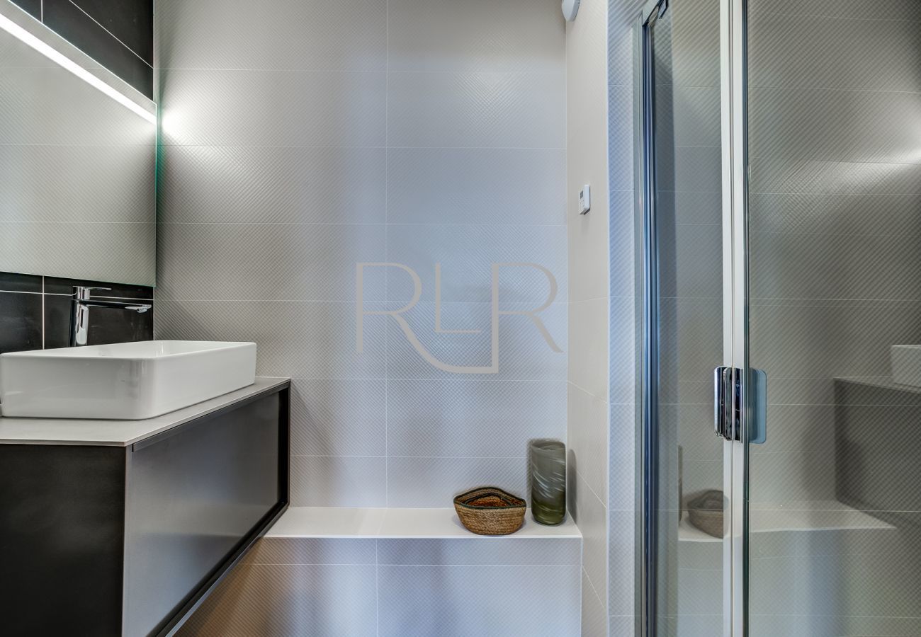 The ensuite to Bedroom 1 of White Pearl A36 has a shower and basin