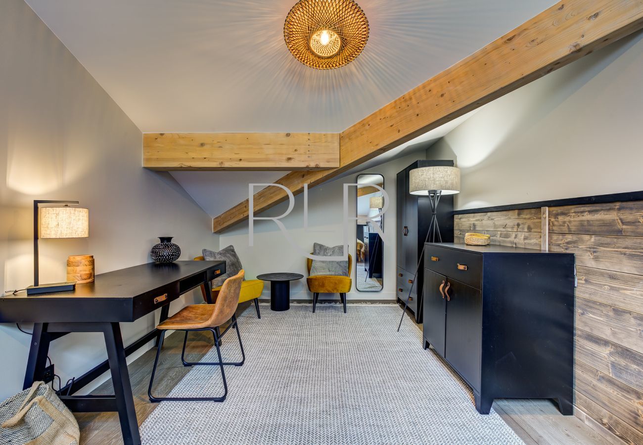 Bedroom 3 of White Pearl A36 is spacious with a desk and cosy seating area