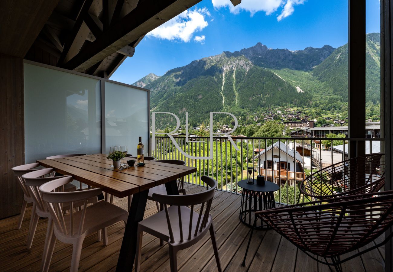 The balcony has outdoor furniture for both dining and relaxing. 