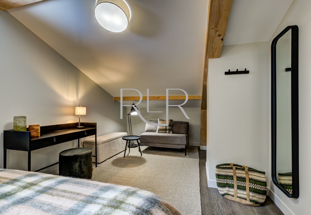 Bedroom 2 of White Pearl A32 is spacious with a cosy seating area 