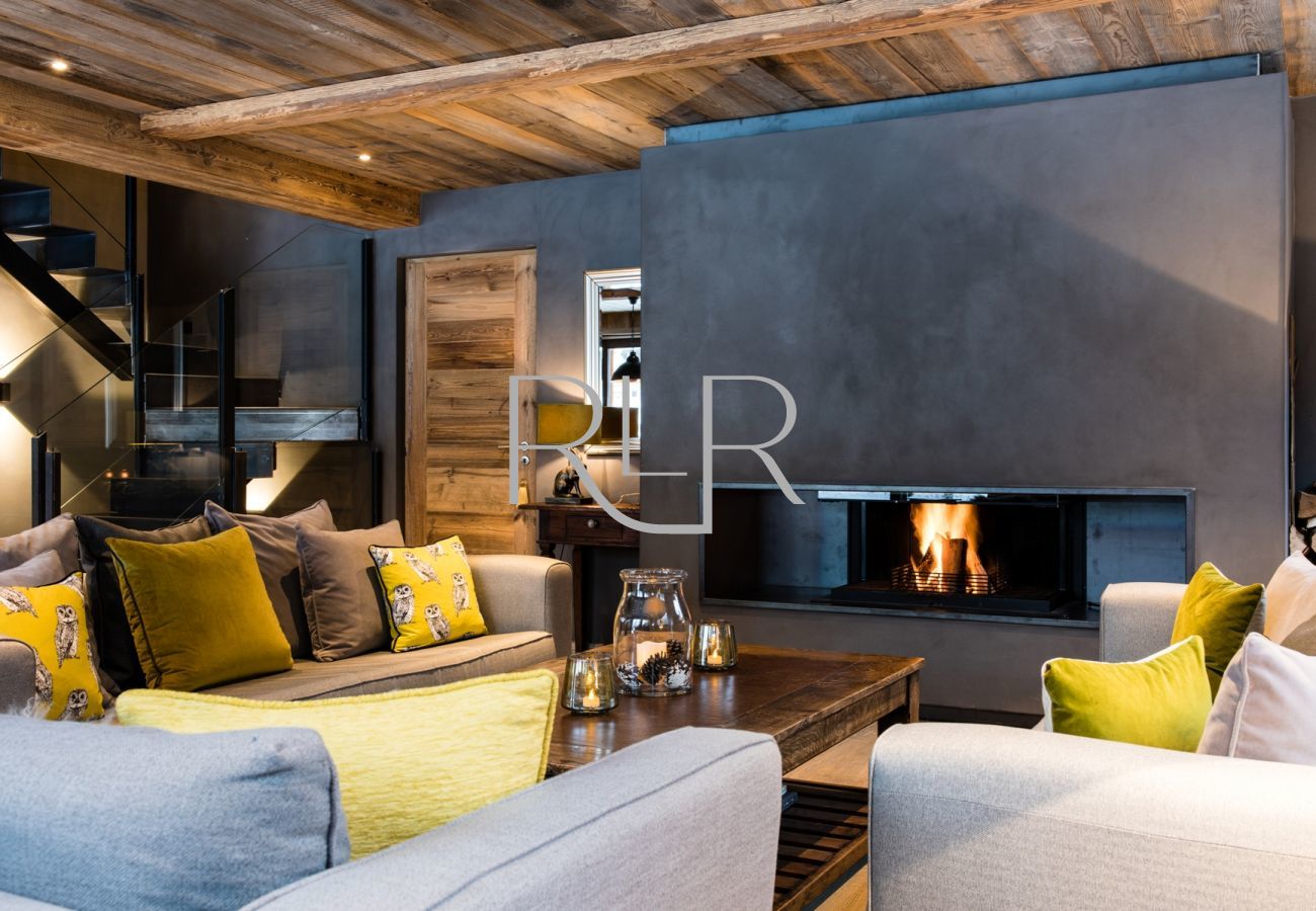 Chalet Seren has comfy sofas around a contemporary log fireplace