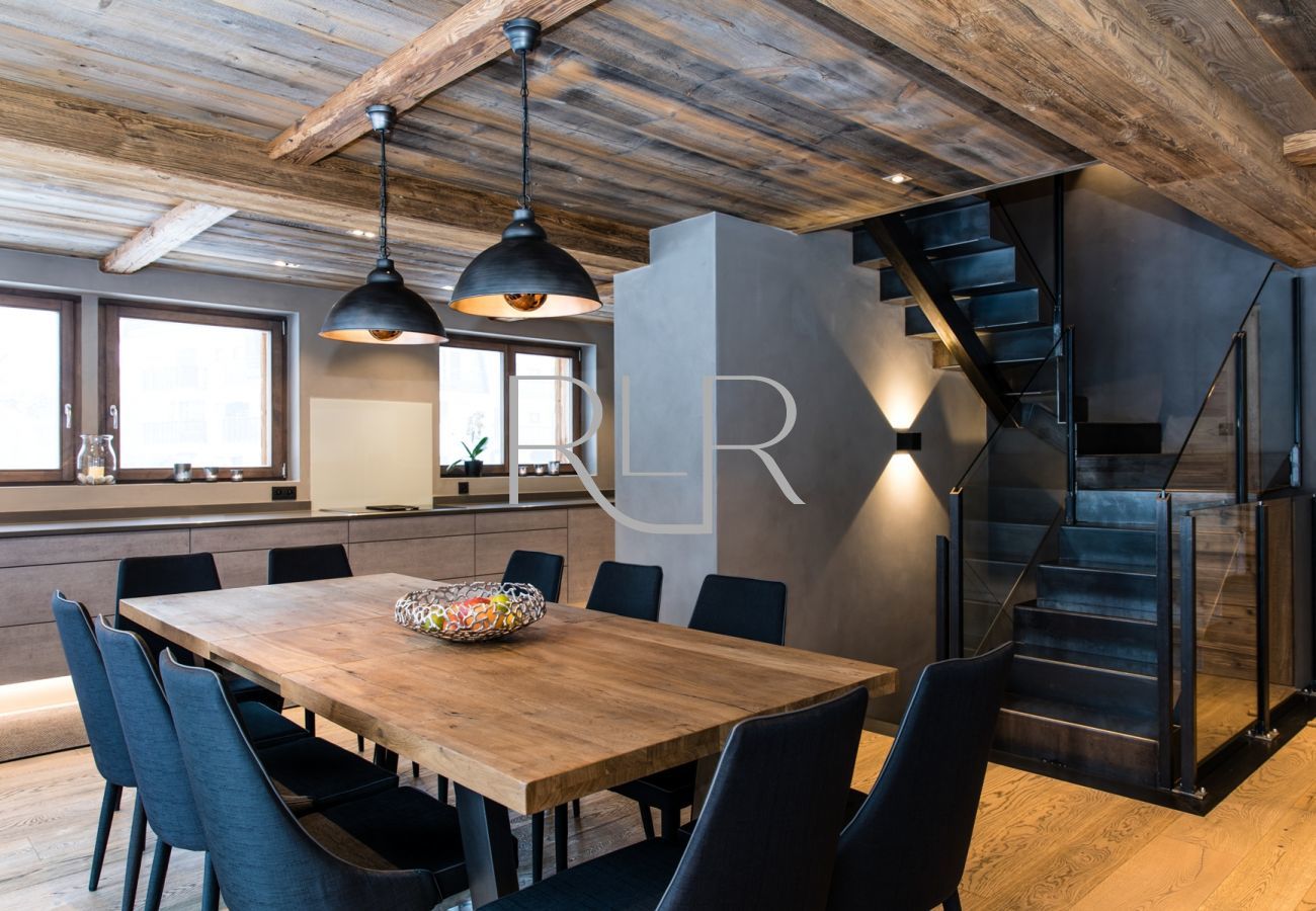 Chalet Seren has a dining table for 10 in front of glass doors onto deck