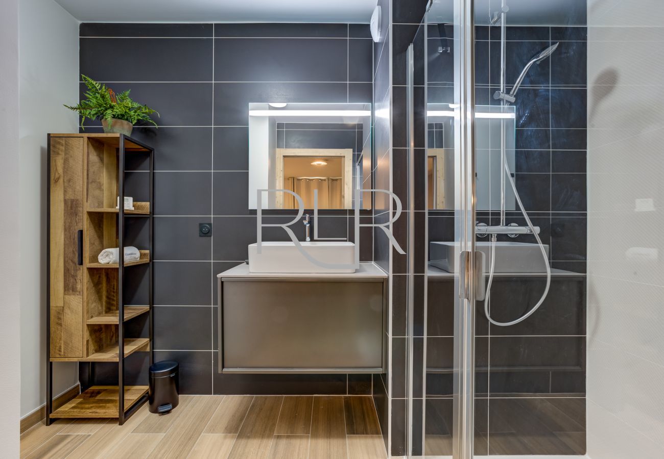 The ensuite to Bedroom 1 of White Pearl A12 has a shower and basin
