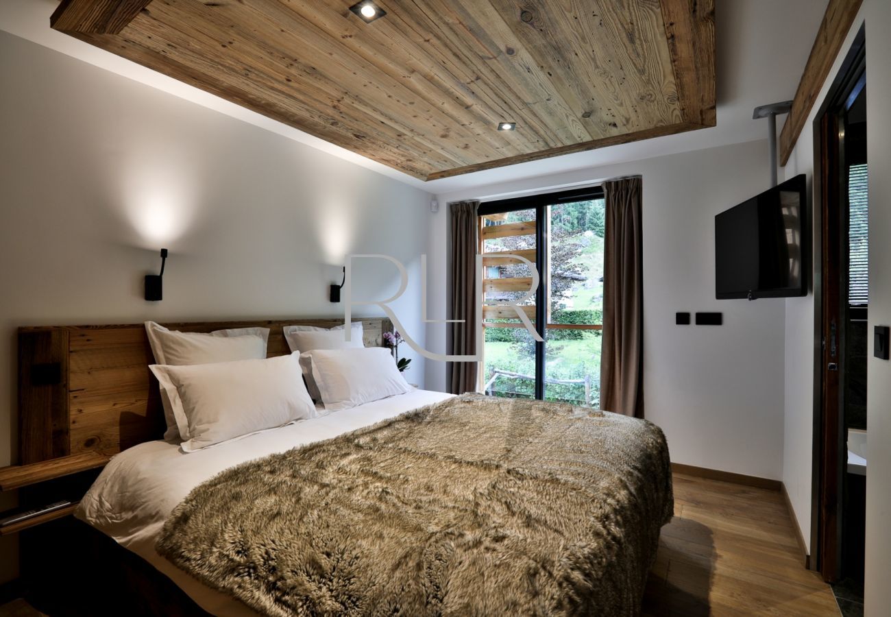 Bedroom 5 of Chalet Black Stone has a glass door onto the balcony