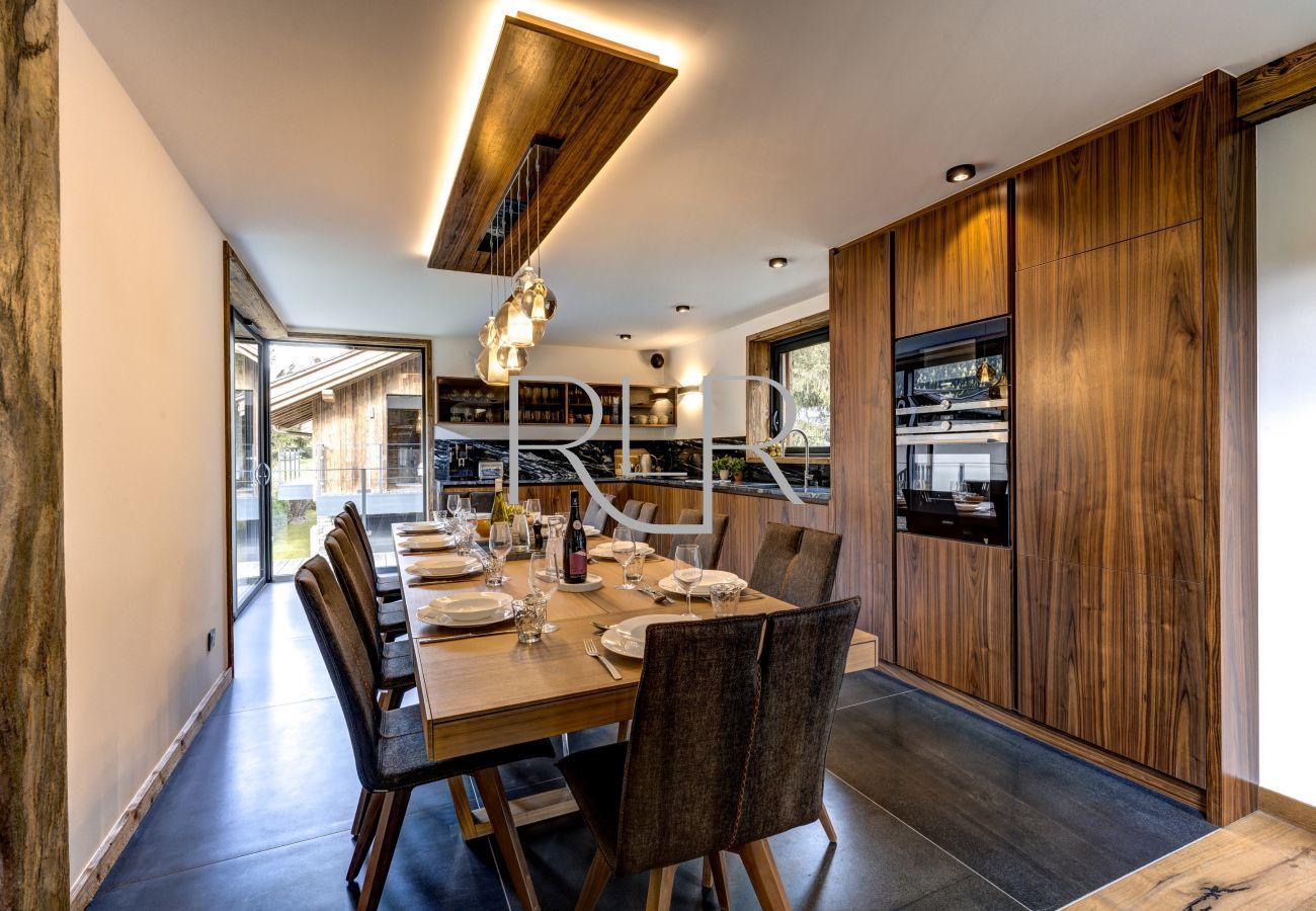 Chalet les Côtés du Lavancher has a stylish kitchen, dining area with large corner windows.