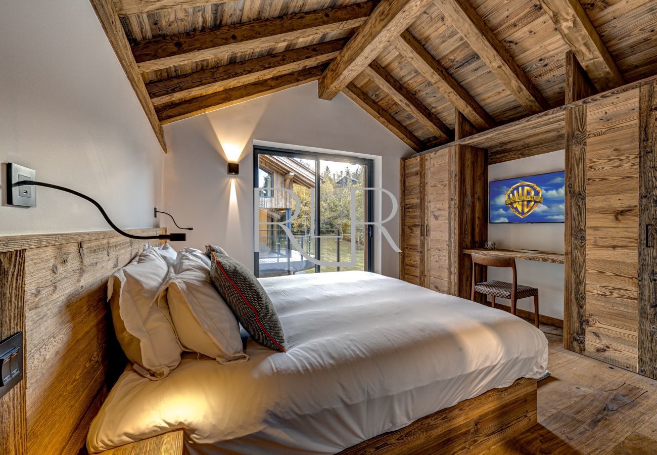 At Chalet les Côtés du Lavancher, Bedroom 4  has glass doors onto a balcony.