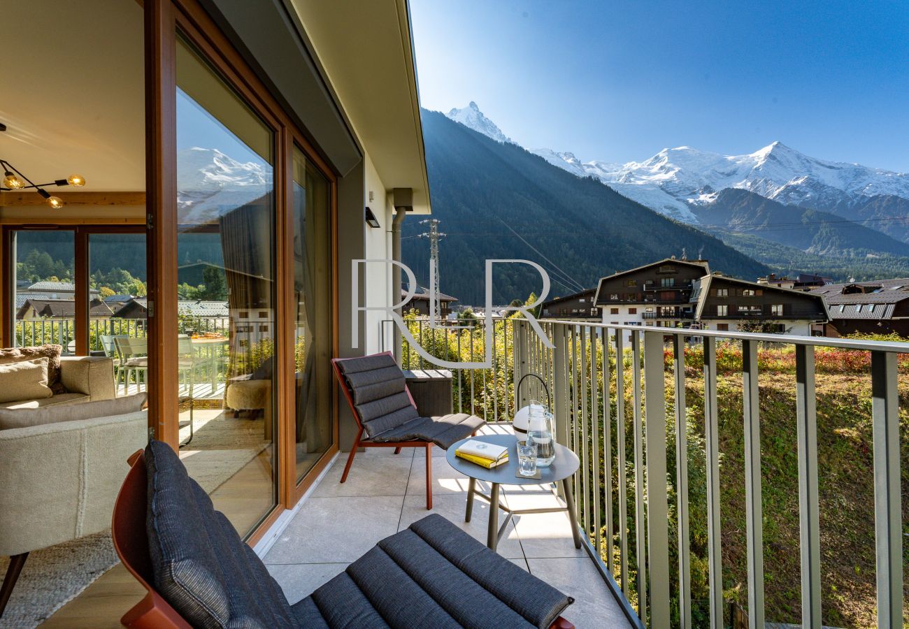 Exterior lounge chairs at Blanc Mont Blanc 303 create the perfect spot to relax.